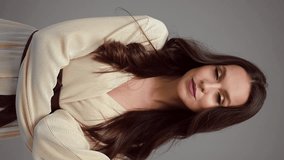 Beautiful brown-haired girl with a perfectly flying hair, classic make-up and a light dress. Beauty face and hair. - Powered by Shutterstock - Get 15% off with code: PIKWIZARD15