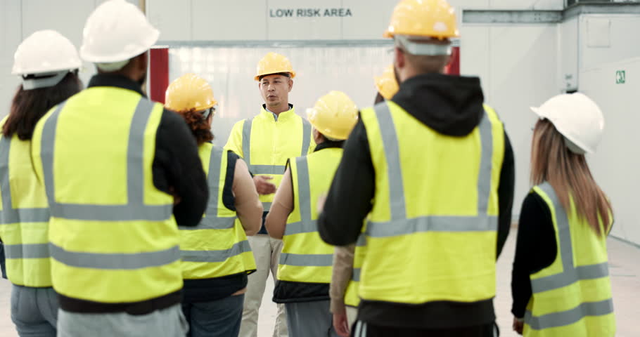 Factory, worker and group with question for manager in meeting for safety inspection and industrial rules for workplace. Manufacturing, team and supervisor speaking or training warehouse staff Royalty-Free Stock Footage #1108000215