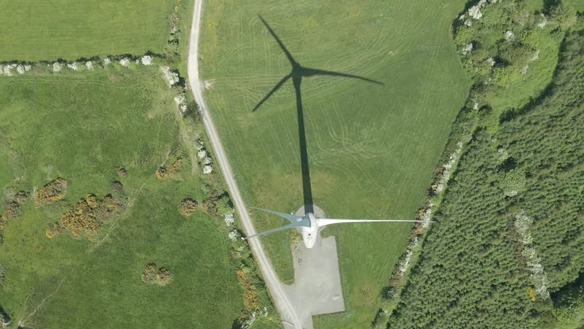 Overhead View Of Wind Turbines With Shadow On Grassy Field In Summer. - aerial