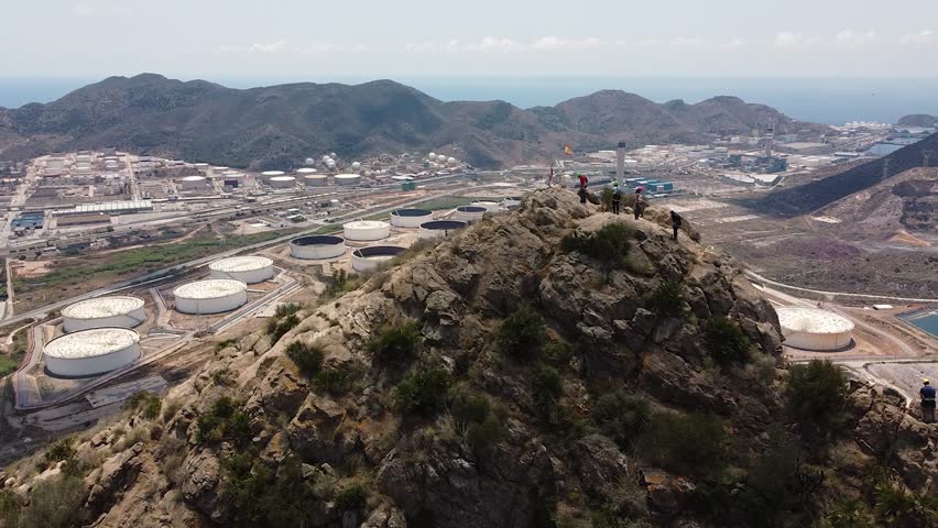 Group of friends do Via Ferrata climb mountain with safety equipment in Cartagena, Region of Murcia, Spain