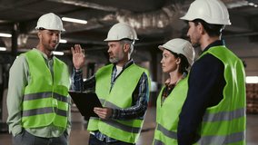 Diverse Team of Engineering Professionals Collaborating and Discussing Work Processes at the Logistic Centre. Male Supervisor Engaging in Conversation with Staff Members. Teamwork Concept - Powered by Shutterstock - Get 15% off with code: PIKWIZARD15