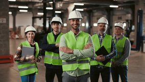 Smiling Face Diverse Team of Machine Technicians in Safety Uniform Standing with Arms Crossed in Warehouse, Looking at Camera at Industrial. Logistic Company. Teamwork Concept - Powered by Shutterstock - Get 15% off with code: PIKWIZARD15