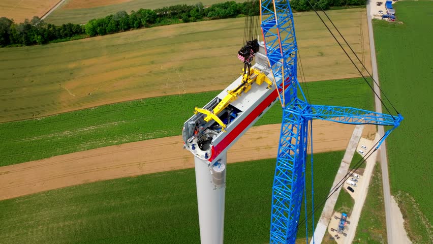 Assembly Of Wind Turbine Nacelle From Above. aerial ascend