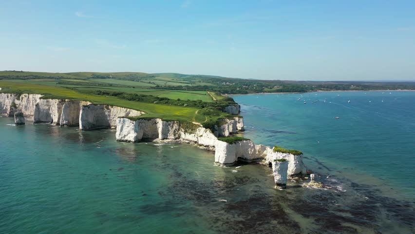An aerial forward panning drone shot of Old Harry Rocks on the Jurassic Coast of Dorset. Hardfast Point at Sudland Bay, England. 50fps