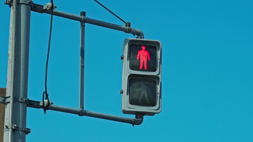 Blue sky and pedestrian traffic light From red to green Royalty-Free Stock Footage #1108012573