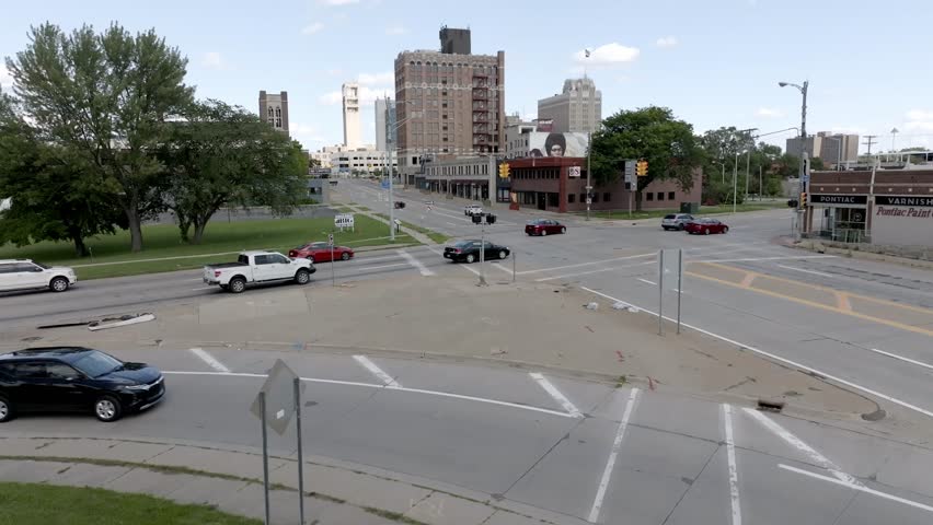 Pontiac , Michigan , United States - 08 19 2023: Traffic at an intersection in downtown Pontiac, Michigan.