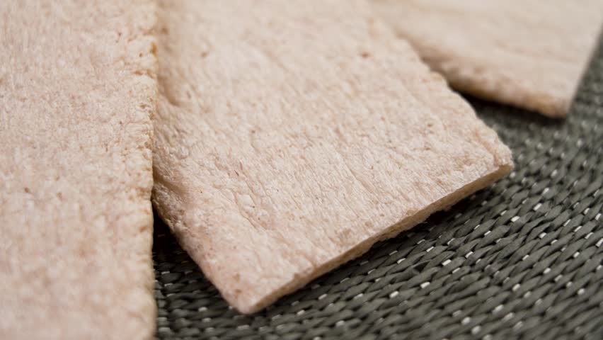 Gluten free buckwheat crispbreads sprinkled with psyllium husk on a rough cloth. Healthy dietary food. Slow motion. Rotation. Royalty-Free Stock Footage #1108014195