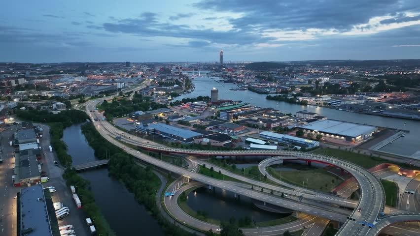 Traffic on highway and cityscape of Gothenburg, Sweden. Aerial drone view in the evening.
