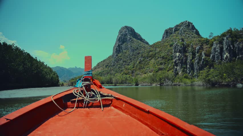 Sailing down a river in Thailand surrounded by limestone hills