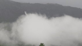 nature video background of the rain falling blurred,seeing the mist, Ngao waterfall on the high mountain in Ranong of Thailand,the beauty of travelers from all over the world always come to see.