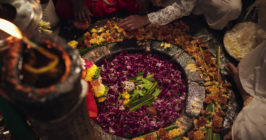 Hindu Religious Ceremony: Slow Motion of Group of Anonymous People Arranging Flowers Next to an Idol During a Shiva Aarti Ritual in a Temple. Devoted Indian Worshipers Praying to Their Deity Royalty-Free Stock Footage #1108032177