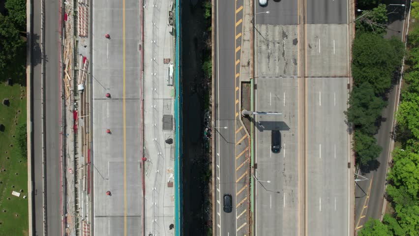 Aerial view of smooth traffic flow on side-by-side highways. 4K 60fps drone clip.