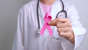 Pink October Breast Cancer Awareness month, doctor with pink Ribbon in hospital for support people life and illness. National cancer survivors month, Mother and World cancer day concept - Powered by Shutterstock - Get 15% off with code: PIKWIZARD15
