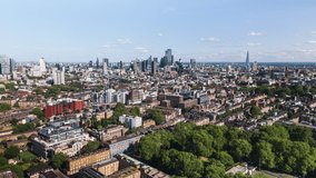 Aerial View Shot of London UK, United Kingdom, green summer, London Skyline, City of London, Shard, St Pauls, Farringdon, Angel, Barbican, Spitalfields, Clerkenwell, circling right