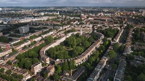 Aerial View Shot of London UK, United Kingdom, green summer, london neighbourhood, victorian houses, homes, suburbs, victorian homes, day sun, Thornhill Square Gardens, Islington, Camden Town