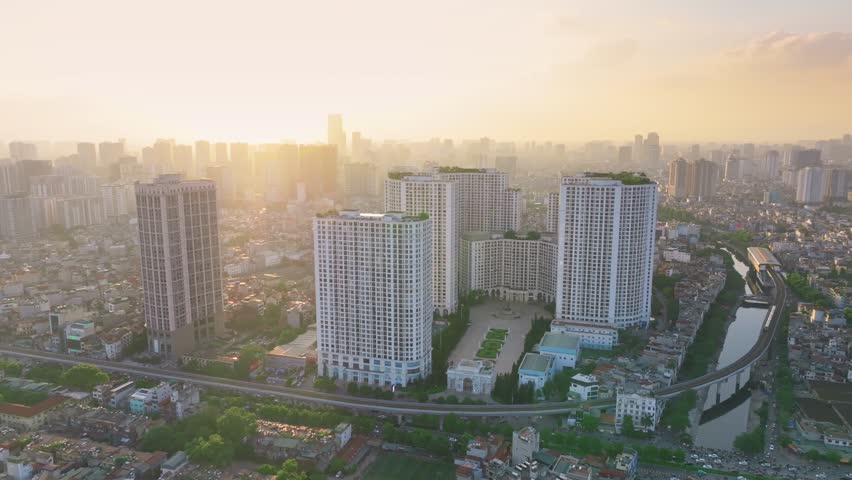 Royal City Urban Area Adjacent to Nguyen Trai Road, Elevated Train Passing Through, Modern Urban Landscape, Hanoi, Vietnam in the sunset