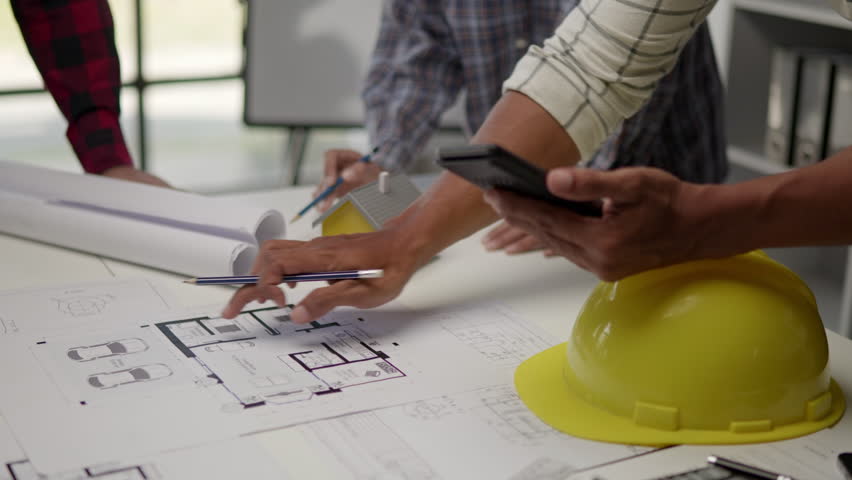 Close up of hands working brainstorming and measuring for cost estimating on paperworks and floor plan drawings about design architectural and engineering for houses and buildings. 50fps. Royalty-Free Stock Footage #1108042083