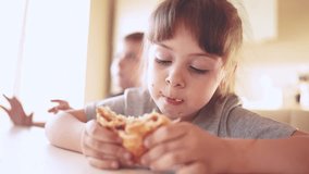children eat burgers. fast food burger. a group of small children in the kitchen greedily eat fast food burgers. big sun family small kids having breakfast in the morning in the kitchen eating burger - Powered by Shutterstock - Get 15% off with code: PIKWIZARD15