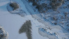 Bird's-eye view of a snow-covered landscape with land, water and trees creating interesting textures and shapes - Powered by Shutterstock - Get 15% off with code: PIKWIZARD15