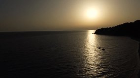 Aerial view of the wild sea beach at the sunset on the Ionian coast in Greece. Top view from drone.