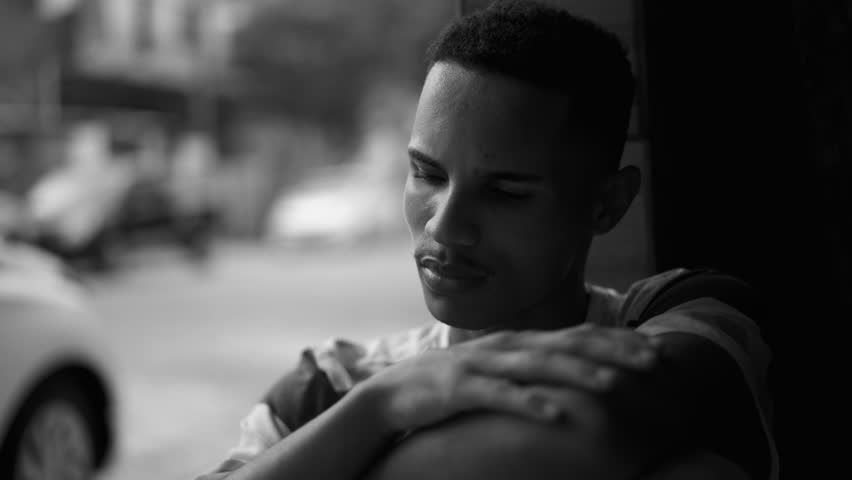 One Depressed Young Black Man Struggles with Social Isolation and Mental Illness, Covering Face in Shame and Regret, Person of African American Descent Facing Quiet Despair Royalty-Free Stock Footage #1108048495