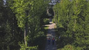 Uniformed workers walking in woods. Clip. Workers in uniform go to cut wood on sunny summer day. Top view of two workers walking along forest road - Powered by Shutterstock - Get 15% off with code: PIKWIZARD15