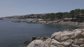 Raw Drone Footage of Coastal Village With Marina and Forest Ending in Beach