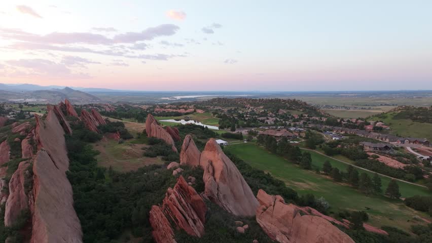 Birds eye view of Arrowhead settlement and golf course over huge rock formation. Evening in Colorado.