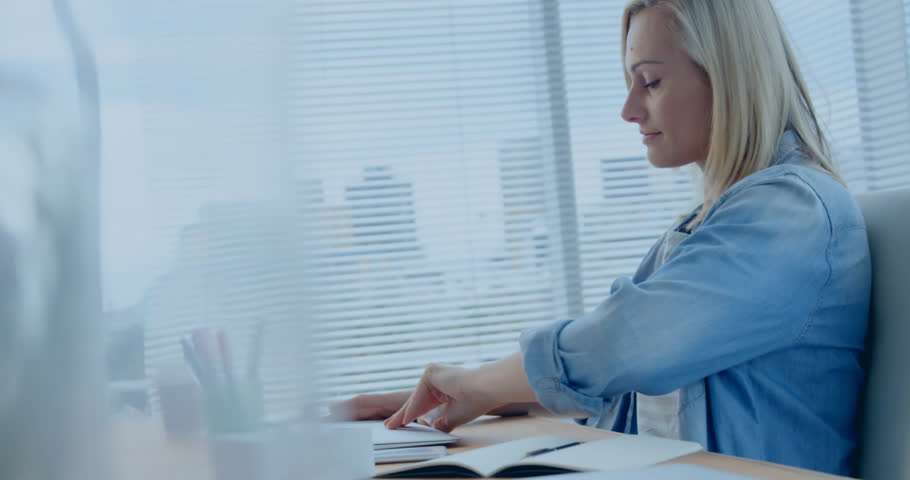 Animation of computer language, numbers, loading bars, caucasian woman working on laptop in office. Digital composite, multiple exposure, progress, growth, coding and technology concept.