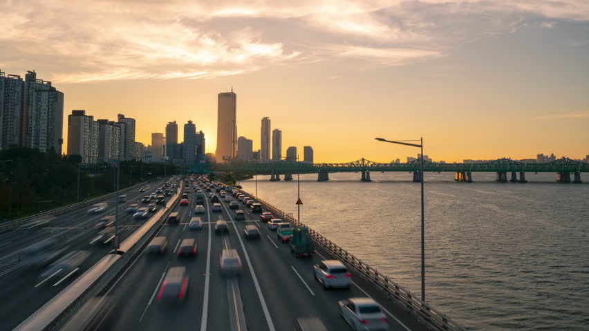 Sun Setting Over Seoul Yeouido 63 Building, View From Hangang Bridge on Cars Traffic on Olympic Expressway - elevated view Royalty-Free Stock Footage #1108057295