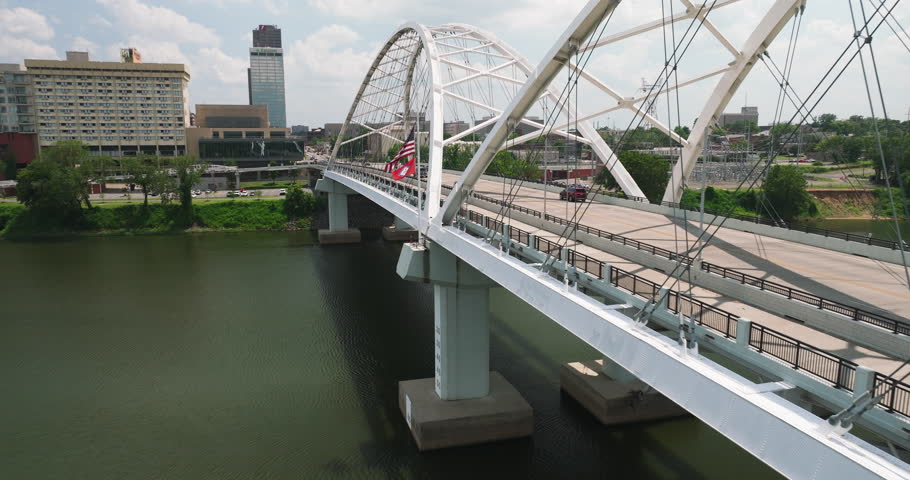 USA And Arkansas Flag On The Broadway Bridge With Traffic In Little Rock, Arkansas, USA. - aerial