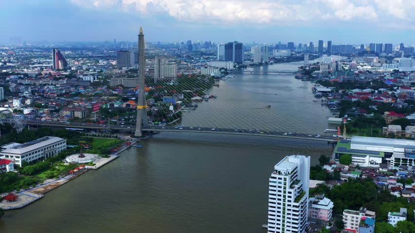 Cars Driving On Rama VIII Bridge Crossing The Chao Phraya River With City Views Of Bangkok In Thailand. - aerial