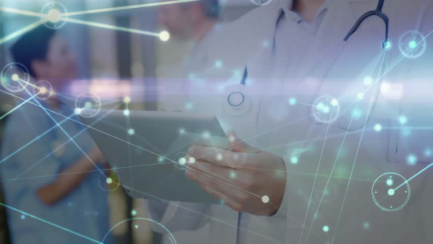 Animation of connected dots and lens flare over caucasian male doctor using digital tablet. Digital composite, telecommunication, medical, healthcare, hospital and wireless technology. - Powered by Shutterstock - Get 15% off with code: PIKWIZARD15