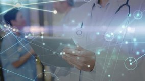 Animation of connected dots and lens flare over caucasian male doctor using digital tablet. Digital composite, telecommunication, medical, healthcare, hospital and wireless technology. - Powered by Shutterstock - Get 15% off with code: PIKWIZARD15