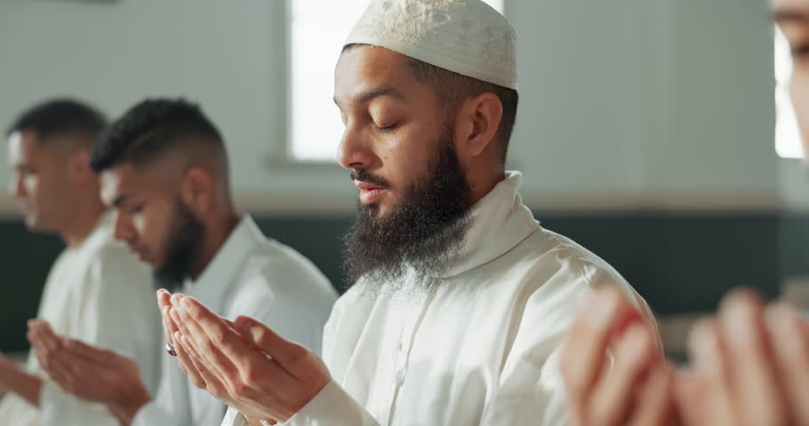 Muslim, praying and group in a Mosque for spiritual religion together as men to worship Allah in Ramadan. Islamic, Arabic and holy people with peace or respect for gratitude, trust and hope for eid Royalty-Free Stock Footage #1108061687