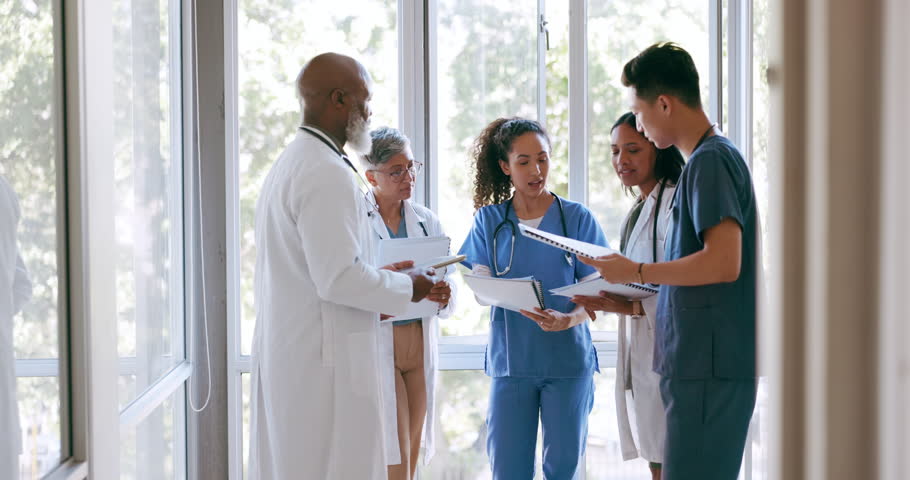 Doctors, group and documents for planning, strategy and discussion for medical solution in hospital. Doctor team, paperwork and teamwork for vision, goal or surgery with black woman giving leadership Royalty-Free Stock Footage #1108062179