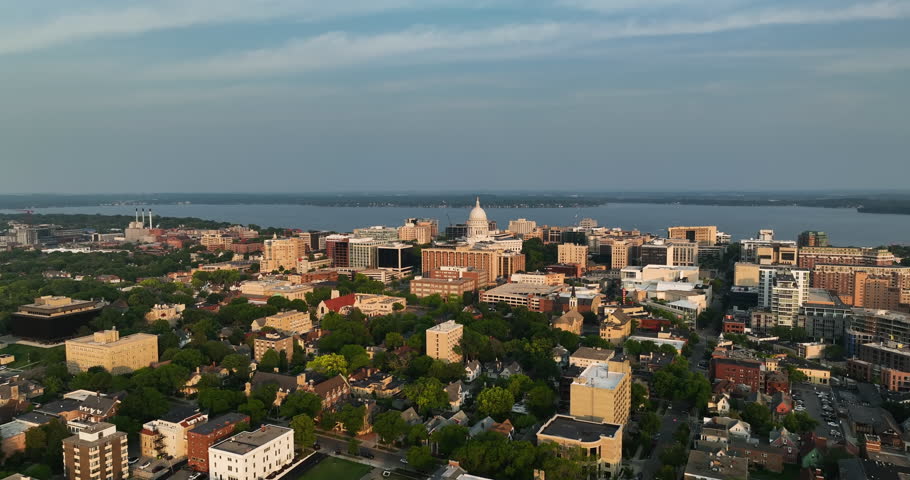 Wide angle aerial shot of Madison downtown buildings and green areas surrounding the city, Wisconsin 