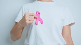 Pink October Breast Cancer Awareness month, woman doctor with pink Ribbon in hospital for support people life and illness. National cancer survivors month, Mother and World cancer day concept - Powered by Shutterstock - Get 15% off with code: PIKWIZARD15