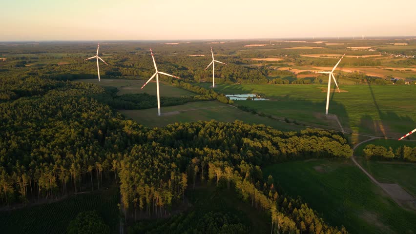 Aerial view of windmills farm for energy production on beautiful cloudy sky at highland. Wind power turbines generating clean renewable energy for sustainable development Royalty-Free Stock Footage #1108075591