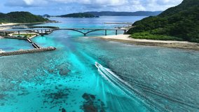 Aerial Footage of Aka island bridge and boats, Kerama, Okinawa Japan. Tourism and marine national parks. Pristine reefs. INTERPRET footage for SMOOTH Playback.