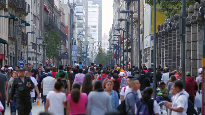 Mexico City, Mexico - February 26, 2023: Crowd of people walking on the busy Madero Street, a historically significant pedestrian street in the historic center of Mexico City, Mexico. 