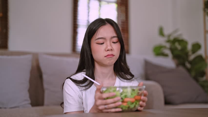 Unhappy Asian women don’t like eating vegetables and want to quit vegetarian, healthy food and dieting concept Royalty-Free Stock Footage #1108079497