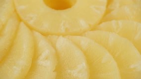 Sliced pieces of canned pineapple fruit, rotate