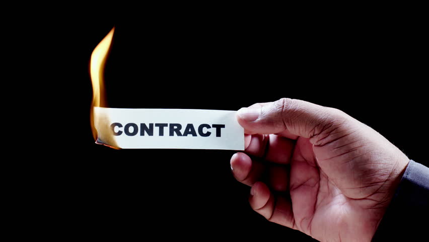 Burning a piece of paper with with word Contract