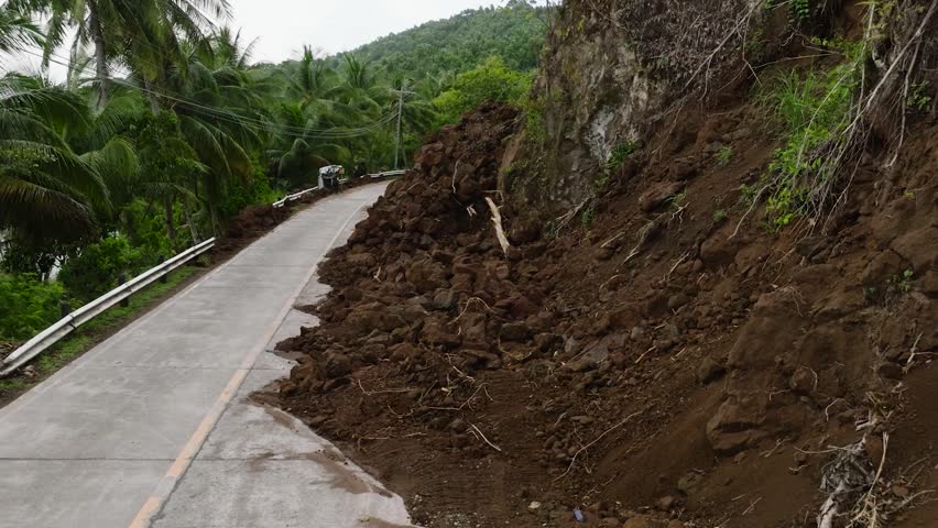 Mountain soil collapse in half of the highway. Landslides due to heavy rainfall. Camiguin, Philippines. Royalty-Free Stock Footage #1108092735