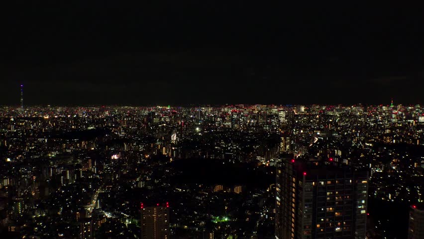 TOKYO, JAPAN : Aerial sunrise view of CITYSCAPE of TOKYO. Dawn sky and buildings at downtown area. Japanese city life and urban metropolis concept 4K video. Long time lapse shot, night to morning. Royalty-Free Stock Footage #1108095009