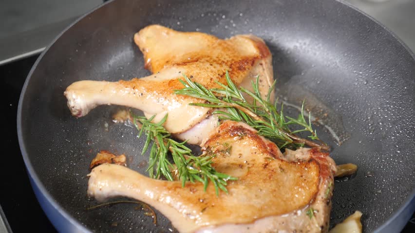 Chef frying Chicken or Duck Legs on frying pan. Slow motion. Traditional French cuisine. Hi-end restaurant. Duck thighs fried with spices. Fine cuisine. Cooking in restaurant. Roasted duck. Full hd Royalty-Free Stock Footage #1108096169