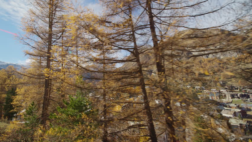 Gornergrat bahn railway running towards summit station with Matterhorn mountain peak background in Zermatt on a sunny winter day. Swiss Alps, Switzerland travel journey trip Shot from train window.