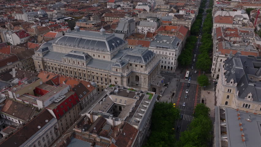 Aerial slide and pan shot of Hungarian State Opera. Beautiful large historic building in city. Budapest, Hungary