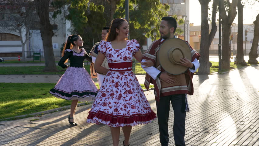 men in huaso costumes lead the women by the arm to dance the cueca in the street Royalty-Free Stock Footage #1108104979